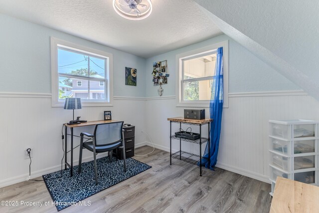 5507 Darlene St, Weeki Wachee, FL 34607 - office featuring a textured ceiling, a wainscoted wall, and wood finished floors