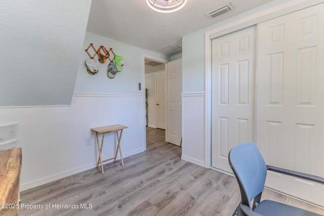 5507 Darlene St, Weeki Wachee, FL 34607 - office space featuring a textured ceiling, a wainscoted wall, and wood finished floors