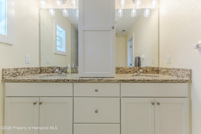 5507 Darlene St, Weeki Wachee, FL 34607 - full bath featuring double vanity and a textured wall