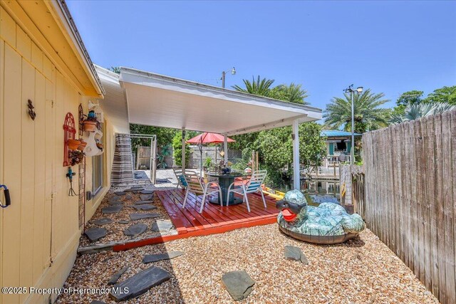 5507 Darlene St, Weeki Wachee, FL 34607 - view of patio with outdoor dining space and a deck