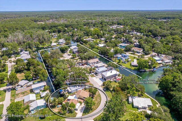 5507 Darlene St, Weeki Wachee, FL 34607 - aerial view of property's location with a heavily wooded area, nearby suburban area, and a nearby body of water