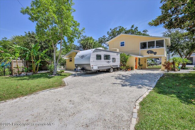 5507 Darlene St, Weeki Wachee, FL 34607 - view of front of house featuring gravel driveway