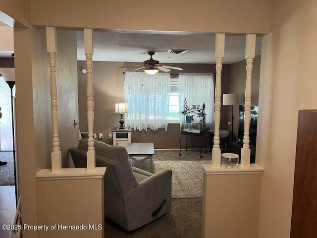12801 Winding Way, Hudson, FL 34667 - carpeted living area featuring ceiling fan and baseboards
