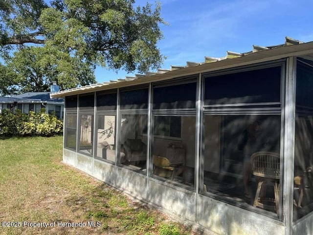 12801 Winding Way, Hudson, FL 34667 - view of side of home with a sunroom and a yard
