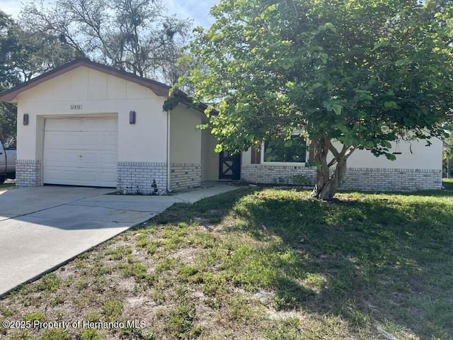 12801 Winding Way, Hudson, FL 34667 - view of front of property featuring brick siding and driveway
