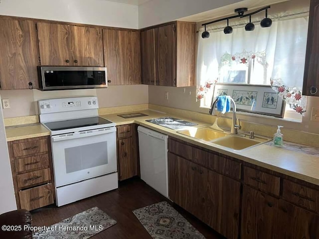 12801 Winding Way, Hudson, FL 34667 - kitchen with white appliances, a sink, light countertops, and dark wood-style flooring