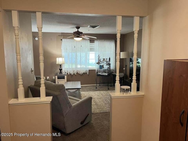 12801 Winding Way, Hudson, FL 34667 - living room featuring ceiling fan, carpet flooring, and baseboards