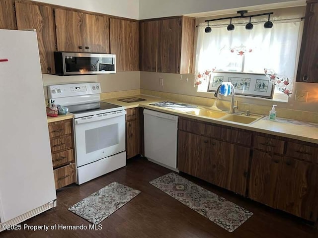 12801 Winding Way, Hudson, FL 34667 - kitchen with white appliances, a sink, light countertops, and dark wood-type flooring
