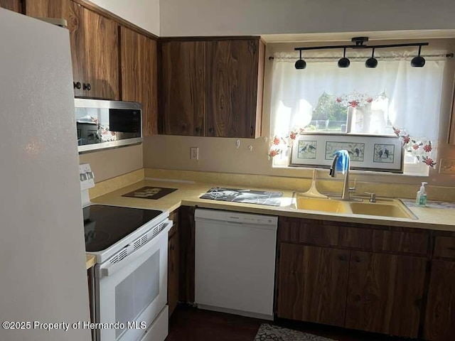 12801 Winding Way, Hudson, FL 34667 - kitchen with white appliances, a sink, and light countertops