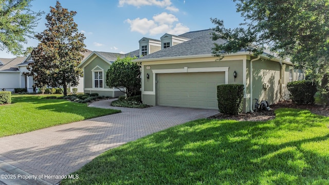 5233 Jennings Trl, Brooksville, FL 34601 - view of front of house with stucco siding, decorative driveway, an attached garage, and a front lawn