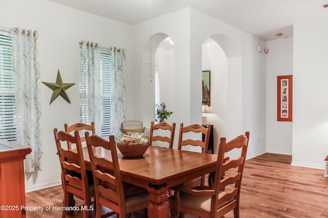 5233 Jennings Trl, Brooksville, FL 34601 - dining room featuring wood finished floors, arched walkways, and baseboards