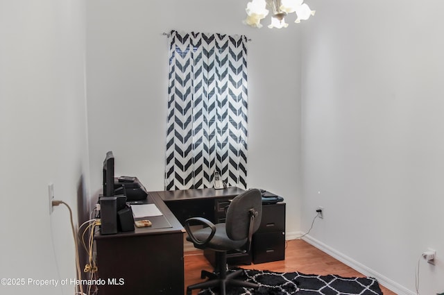 5233 Jennings Trl, Brooksville, FL 34601 - office space with a chandelier, wood finished floors, and baseboards
