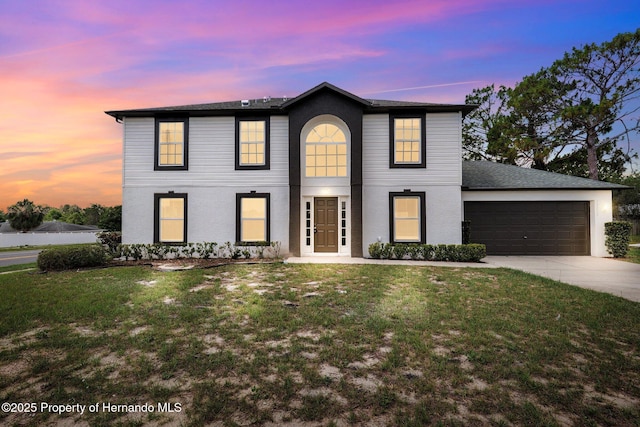 12470 Elgin Blvd, Spring Hill, FL 34609 - view of front facade with concrete driveway, a garage, a front yard, and stucco siding