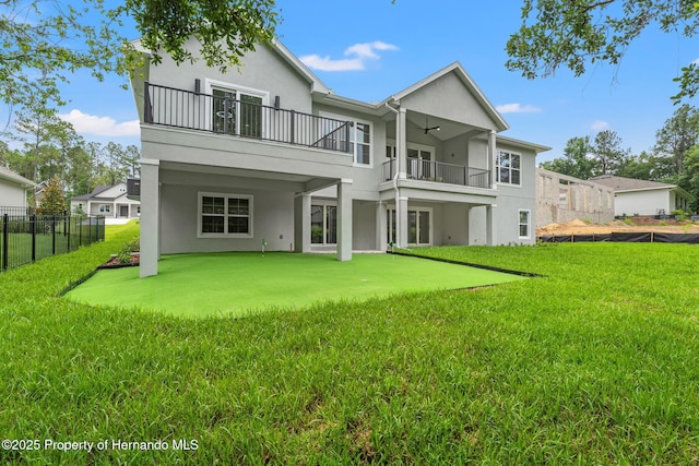4522 Majestic Hills Loop, Brooksville, FL 34601 - back of property with a balcony, stucco siding, and ceiling fan