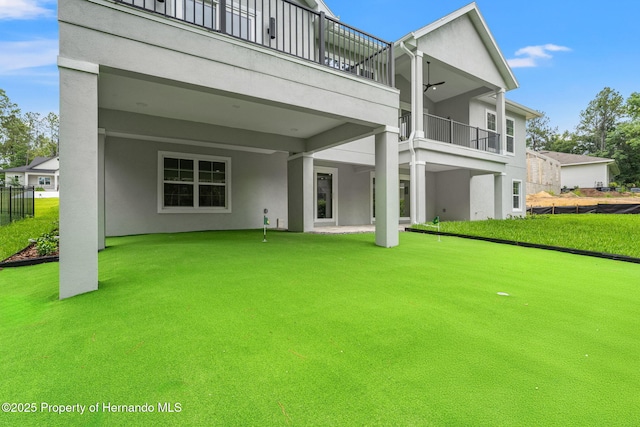 4522 Majestic Hills Loop, Brooksville, FL 34601 - back of house featuring a putting green, stucco siding, and a balcony