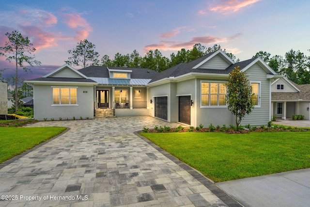 4522 Majestic Hills Loop, Brooksville, FL 34601 - view of front of home featuring decorative driveway, a garage, a yard, and stucco siding