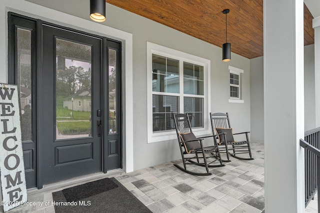 4522 Majestic Hills Loop, Brooksville, FL 34601 - property entrance with a porch and stucco siding