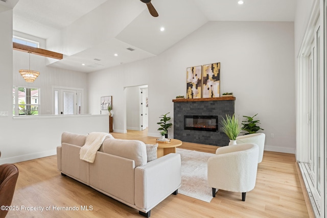 4522 Majestic Hills Loop, Brooksville, FL 34601 - living area featuring high vaulted ceiling, a glass covered fireplace, ceiling fan, light wood-style floors, and recessed lighting