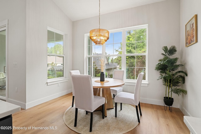 4522 Majestic Hills Loop, Brooksville, FL 34601 - dining room with a chandelier, plenty of natural light, light wood-type flooring, and vaulted ceiling