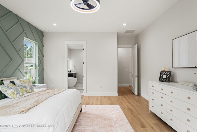 4522 Majestic Hills Loop, Brooksville, FL 34601 - bedroom featuring light wood-type flooring, recessed lighting, and connected bathroom