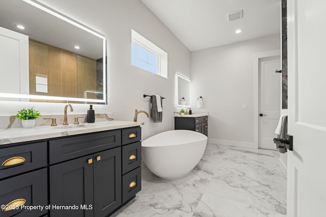 4522 Majestic Hills Loop, Brooksville, FL 34601 - full bath with two vanities, a freestanding bath, marble finish flooring, and recessed lighting