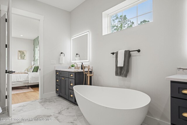 4522 Majestic Hills Loop, Brooksville, FL 34601 - ensuite bathroom featuring vanity, a freestanding bath, and marble finish floors