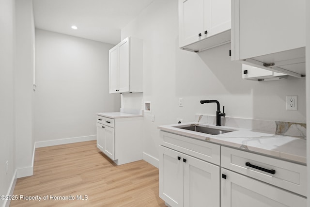 4522 Majestic Hills Loop, Brooksville, FL 34601 - laundry room featuring washer hookup, light wood-type flooring, recessed lighting, and cabinet space