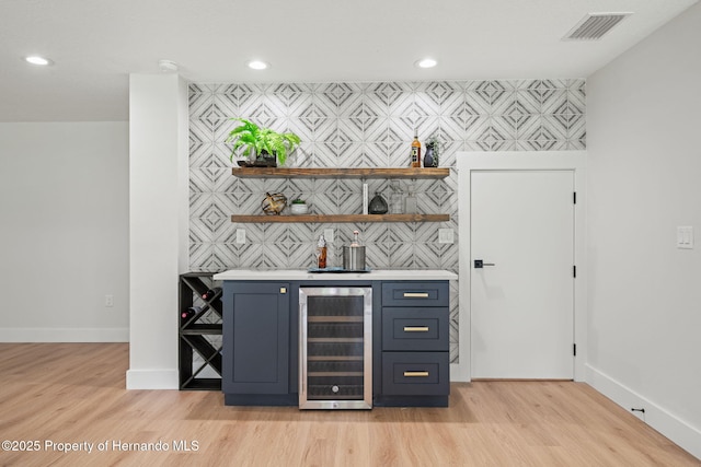 4522 Majestic Hills Loop, Brooksville, FL 34601 - indoor dry bar featuring beverage cooler, an accent wall, recessed lighting, and light wood-type flooring