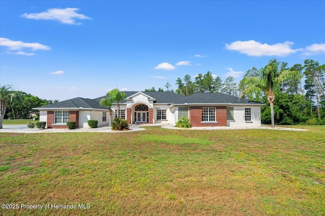 11137 Woodland Waters Blvd, Spring Hill, FL 34613 - ranch-style house featuring a front yard and brick siding