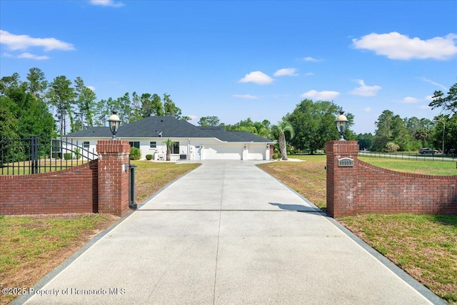 11137 Woodland Waters Blvd, Spring Hill, FL 34613 - ranch-style home featuring concrete driveway and an attached garage
