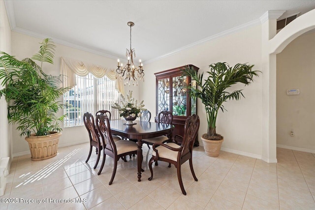 11137 Woodland Waters Blvd, Spring Hill, FL 34613 - dining space featuring crown molding, a chandelier, arched walkways, light tile patterned floors, and baseboards