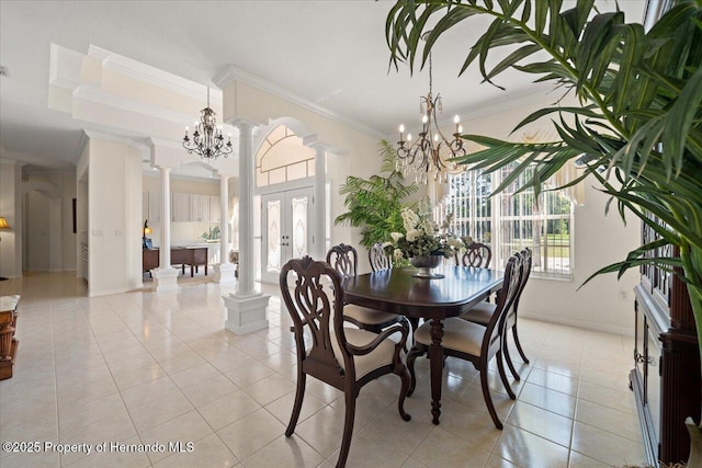 11137 Woodland Waters Blvd, Spring Hill, FL 34613 - dining space featuring ornate columns, ornamental molding, a chandelier, light tile patterned floors, and baseboards
