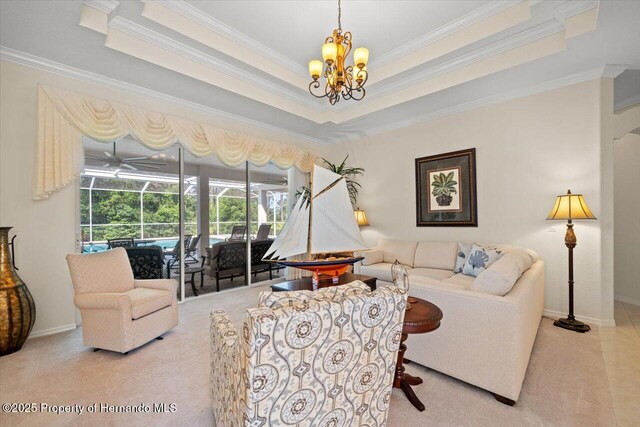 11137 Woodland Waters Blvd, Spring Hill, FL 34613 - carpeted living area featuring ornamental molding, a sunroom, a chandelier, a raised ceiling, and baseboards