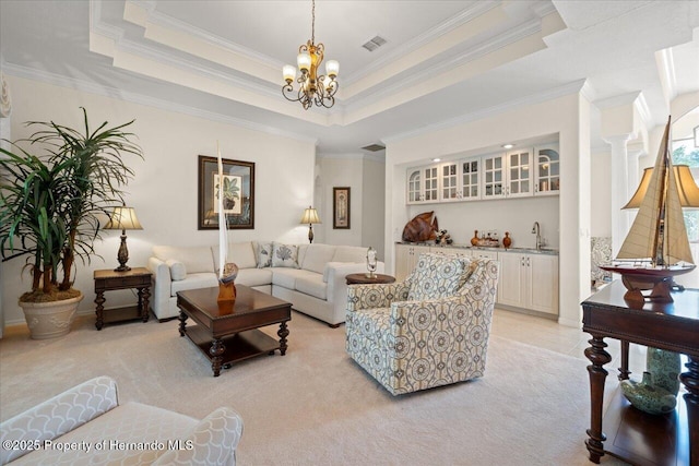 11137 Woodland Waters Blvd, Spring Hill, FL 34613 - living room with a chandelier, light carpet, crown molding, and a raised ceiling