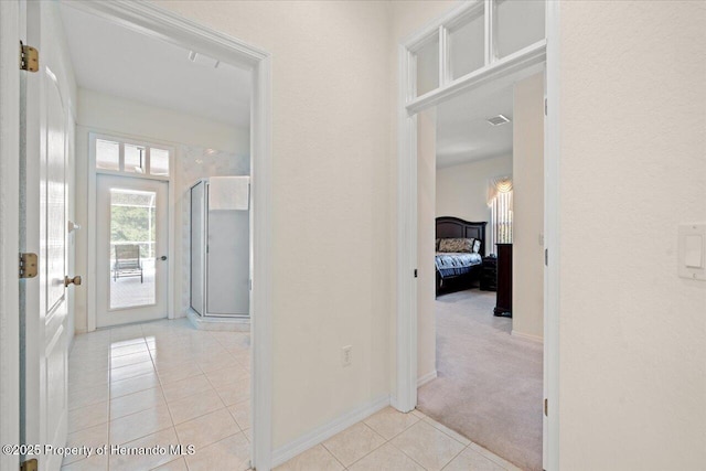 11137 Woodland Waters Blvd, Spring Hill, FL 34613 - corridor with light tile patterned floors, baseboards, and light colored carpet