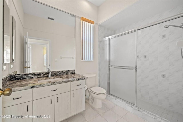 11137 Woodland Waters Blvd, Spring Hill, FL 34613 - bathroom featuring vanity, a stall shower, toilet, and tile patterned flooring
