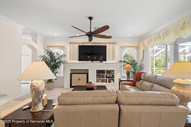 11137 Woodland Waters Blvd, Spring Hill, FL 34613 - living area featuring ceiling fan, crown molding, recessed lighting, a fireplace, and wood finished floors
