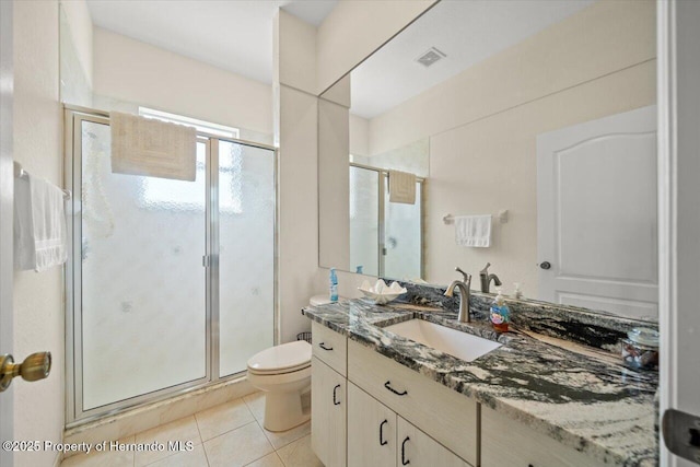 11137 Woodland Waters Blvd, Spring Hill, FL 34613 - bathroom with vanity, tile patterned flooring, a shower stall, and toilet