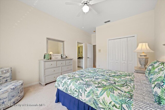 11137 Woodland Waters Blvd, Spring Hill, FL 34613 - bedroom featuring light carpet, a closet, a ceiling fan, ensuite bath, and baseboards