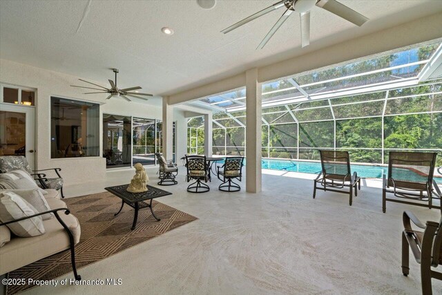 11137 Woodland Waters Blvd, Spring Hill, FL 34613 - swimming pool with a ceiling fan, a patio area, and glass enclosure