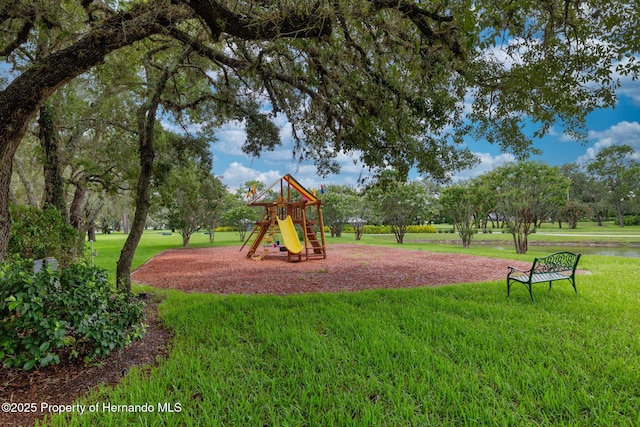 8308 Mobile Cir, Weeki Wachee, FL 34613 - communal playground featuring a lawn