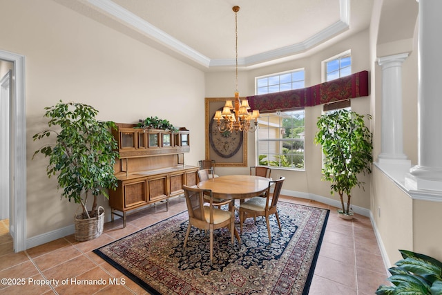 8308 Mobile Cir, Weeki Wachee, FL 34613 - dining space featuring light tile patterned floors, crown molding, a chandelier, ornate columns, and baseboards