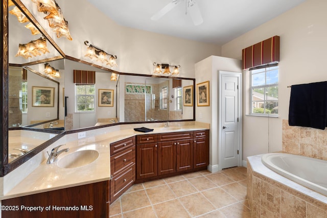 8308 Mobile Cir, Weeki Wachee, FL 34613 - bathroom featuring plenty of natural light, a garden tub, double vanity, and tile patterned floors