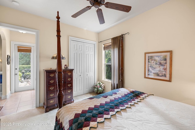 8308 Mobile Cir, Weeki Wachee, FL 34613 - bedroom featuring access to exterior, multiple windows, arched walkways, and a closet