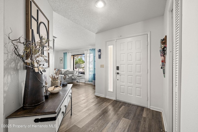 9114 Dorsey St, Spring Hill, FL 34608 - foyer entrance with a textured ceiling, dark wood-type flooring, and baseboards