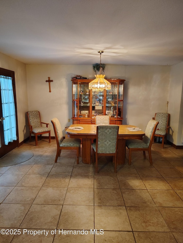 6208 Roble Ave, Spring Hill, FL 34608 - dining space with light tile patterned floors and baseboards