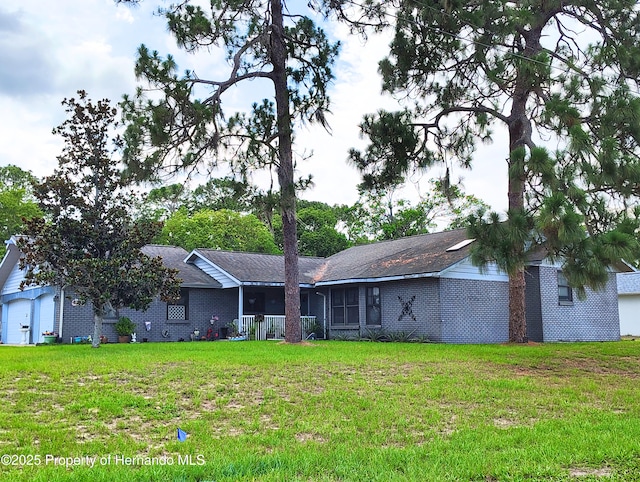 6208 Roble Ave, Spring Hill, FL 34608 - rear view of property with a yard and brick siding