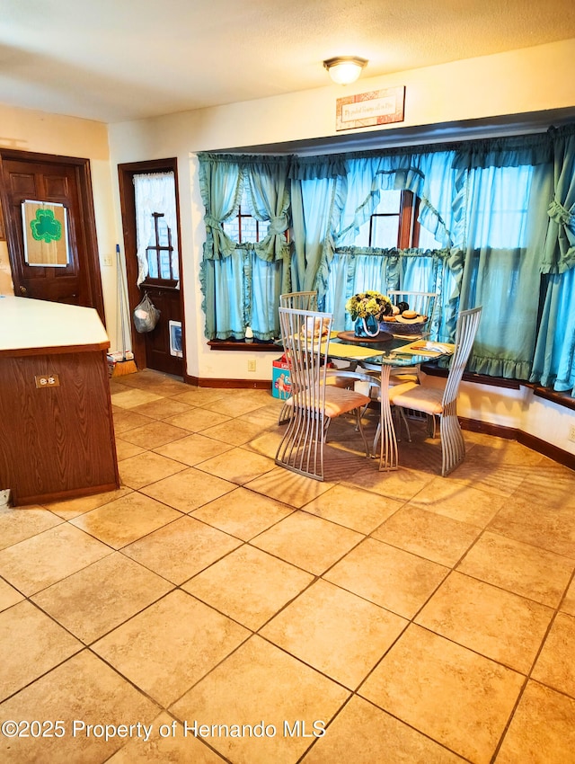 6208 Roble Ave, Spring Hill, FL 34608 - dining space featuring baseboards and light tile patterned floors