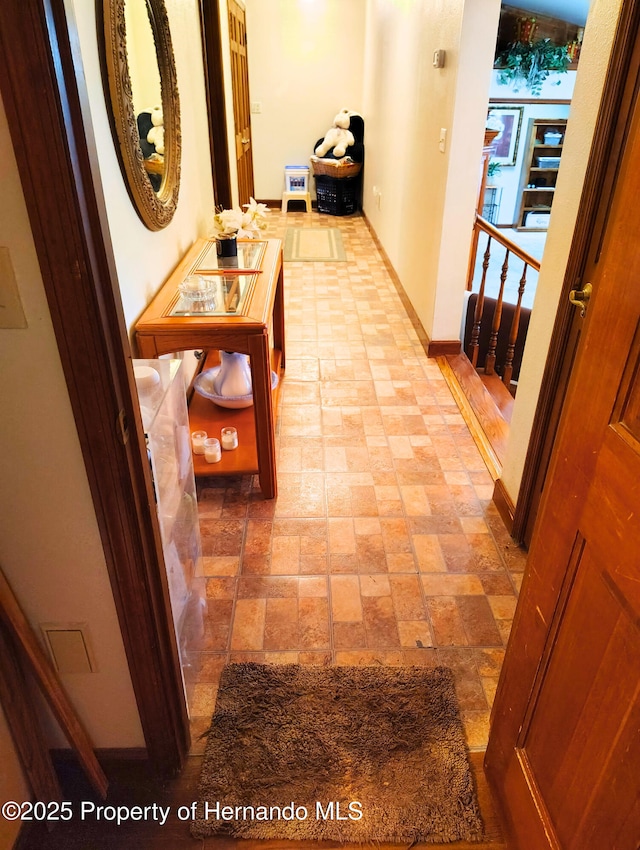 6208 Roble Ave, Spring Hill, FL 34608 - hallway with baseboards and light stone finish floors