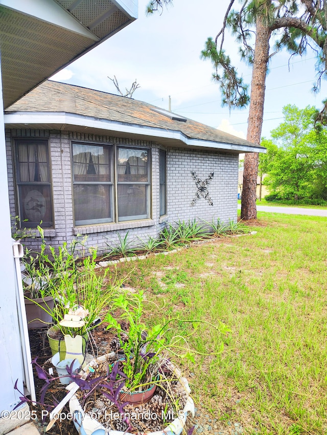 6208 Roble Ave, Spring Hill, FL 34608 - view of side of property with brick siding and a yard